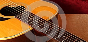 Musical instrument - Closeup fragment pickguard, strings and neck acoustic guitar photo