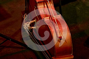 musical instrument double bass with a bow lies on the stage