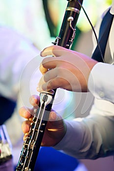 Musical instrument flute in the hands of a male musician