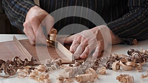 Musical instrument maker pyramiding braces of guitar in workshop, closeup