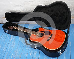 Musical instrument - Orange acoustic guitar in hard case