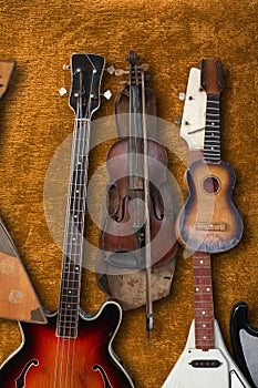 Musical instrument - Vintage bass guitar, acoustic, violin, balalaika brown background