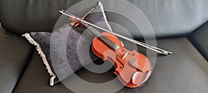 Musical instrument, violin with bow, string instruments, black background, cushion