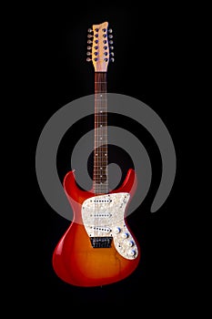 Musical instrument wooden six-string guitar red isolated on blackbackground