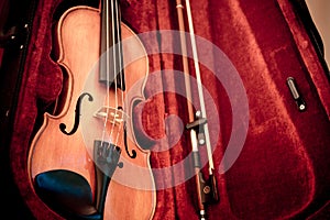 Musical instruments. Close up violin and bow in open dark red case