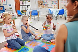 Musical instruments helps the body and mind work together. children learning about musical instruments in class.