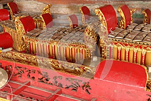 Musical instruments in a Hindu temple on Bali island, Indonesia. Gamelan or gamelang is a musical instrument that is played using