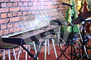 Musical instruments in a room. Electric piano, microphone and st