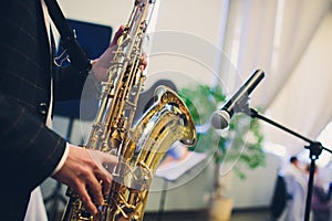 Musical instruments, Saxophone Player hands Saxophonist playing jazz music. Alto sax musical instrument closeup.