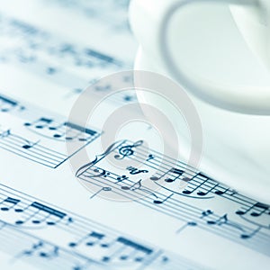 Musical notation and a white coffee cup