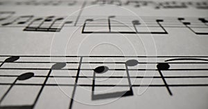 Musical notes printed on sheet of paper closeup