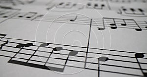 Musical notes printed on sheet of paper closeup