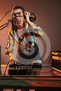 Musical performer mixing music at dj turntables