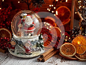 Musical Snow Globe with Santa Claus on bokeh background