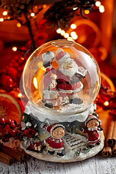 Musical Snow Globe with Santa Claus on bokeh background