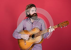 musical string instrument. mature charismatic male guitarist. guy with beard and moustache play guitar. bearded man in