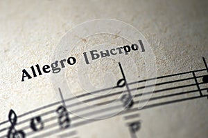Musical tempo `Allegro` in a music notebook photo