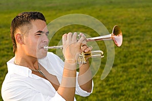 The musician blows the trumpet