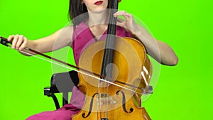 Musician bows the strings of the violin. Green screen