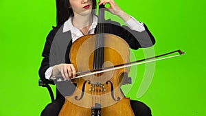 Musician bows the strings of the viololla playing . Green screen