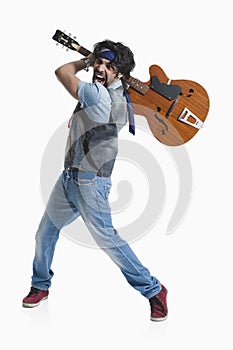 Musician breaking a guitar