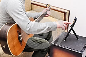 Musician composes a song on the guitar photo