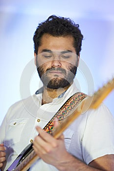 Musician concentrating on the chords of his guitar