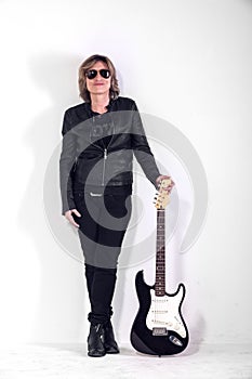 Musician dressed in black leather on white background