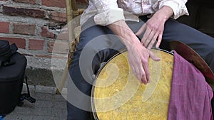 Musician drummer hands playing with drum in street