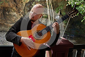 Musician expressing himself through guitar playing in outdoor ambiance photo