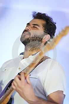 Musician with guitar playing music in studio