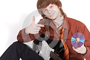 Musician with guitar selling compact disc