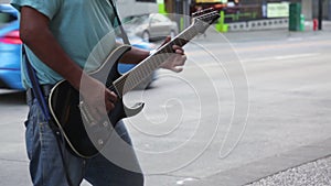 Musician guitarist playing street car limosine passing by