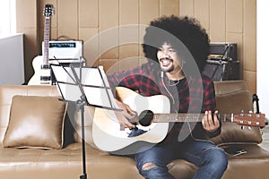 Musician with hands in guitar inside recording studio