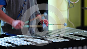 Musician hands playing vibraphone : a big aluminum metal xylophone, a musical instrument metallophone