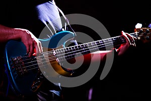 Musician holding bass guitar performing