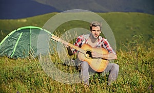 Musician looking for inspiration. Dreamy wanderer. Pleasant time alone. Peaceful mood. Guy with guitar contemplate