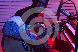 Musician and making music concept - African american male sound producer working in recording studio, close-up.