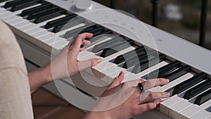 Musician is making music, playing by digital piano