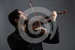 Musician man playing the violin. Musical instrument on performer