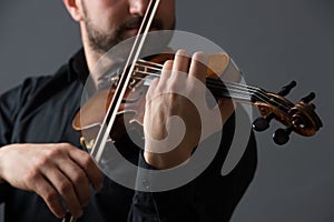 Musician man playing the violin. Musical instrument on performer