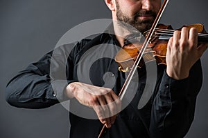 Musician man playing the violin. Musical instrument on performer