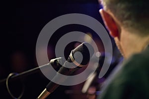 Musician and microphone at rock-concert