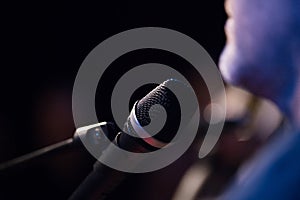 Musician and microphone at rock-concert, horizontal