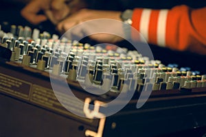 Musician mixing on audio board