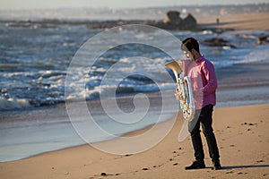 Musician with musical instrument Tuba on romantic sea shore. Concert.