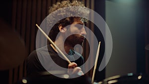 Musician nodding head in studio. Drummer making rock music in concert hall.