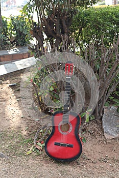 The musician places his red Fender Squier Stratocaster-A beautiful strap for a guitar made of genuine leather