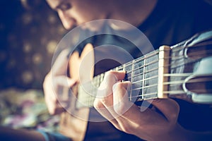 Musician playing acoustic guitar