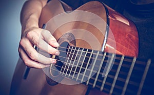 Musician playing acoustic guitar